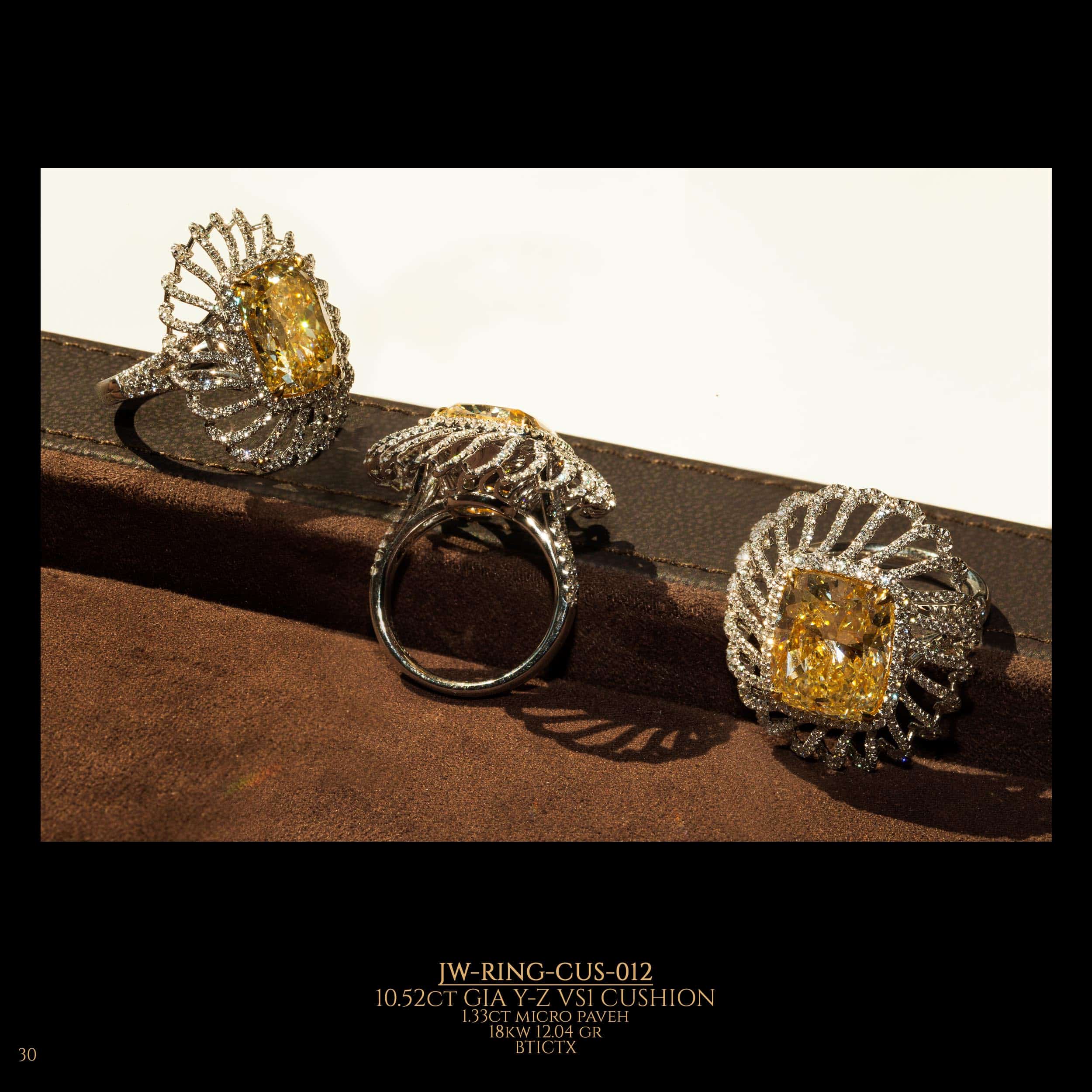 Unique shape diamond ring with large fancy yellow cushion diamond in the center