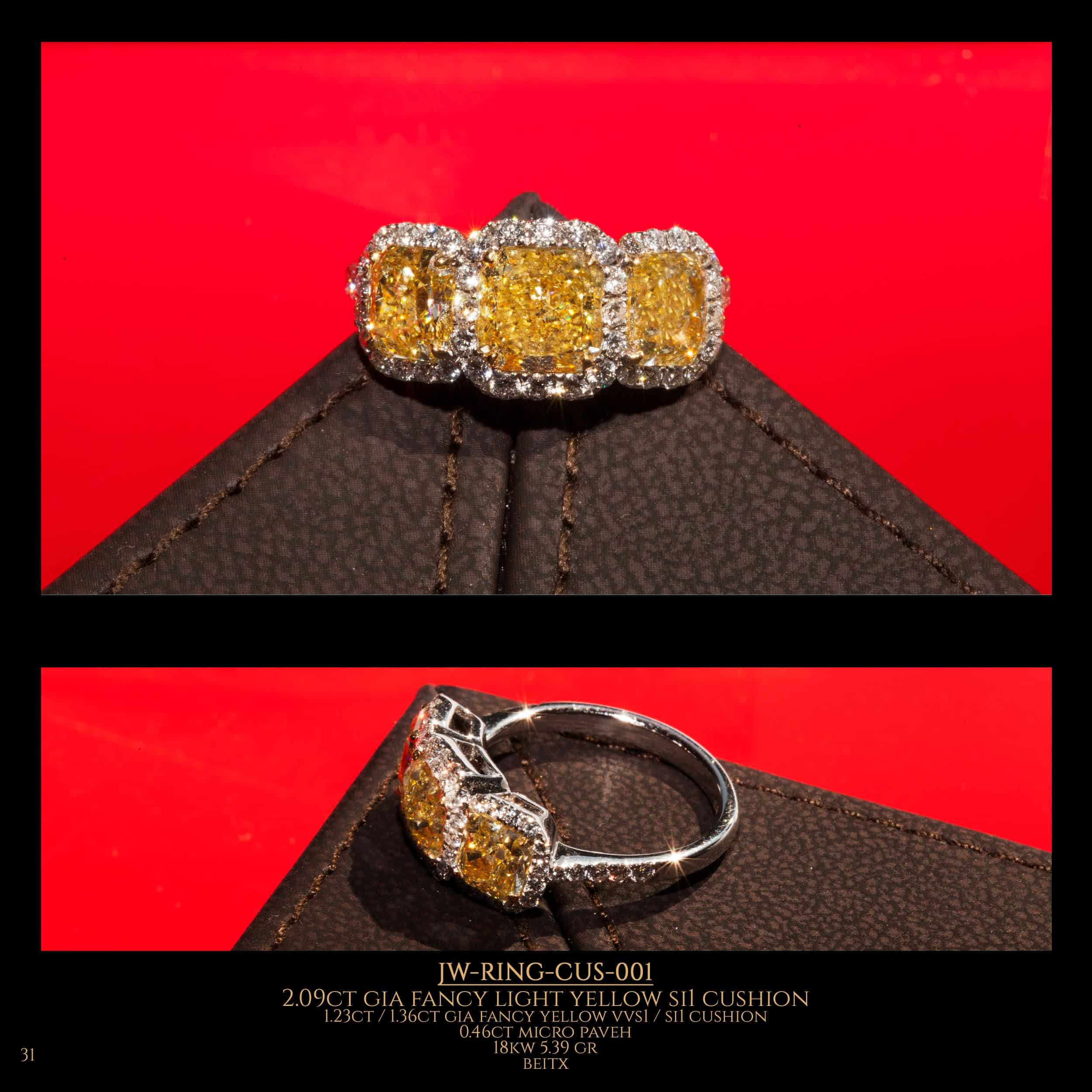 Diamond ring with 3 fancy yellow cushion diamond in the center on a red background