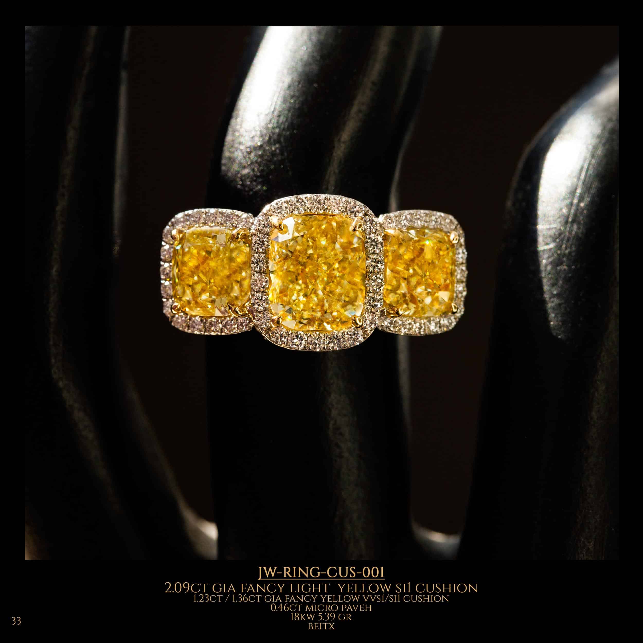 Diamond ring with 3 fancy light yellow cushion diamonds in the center