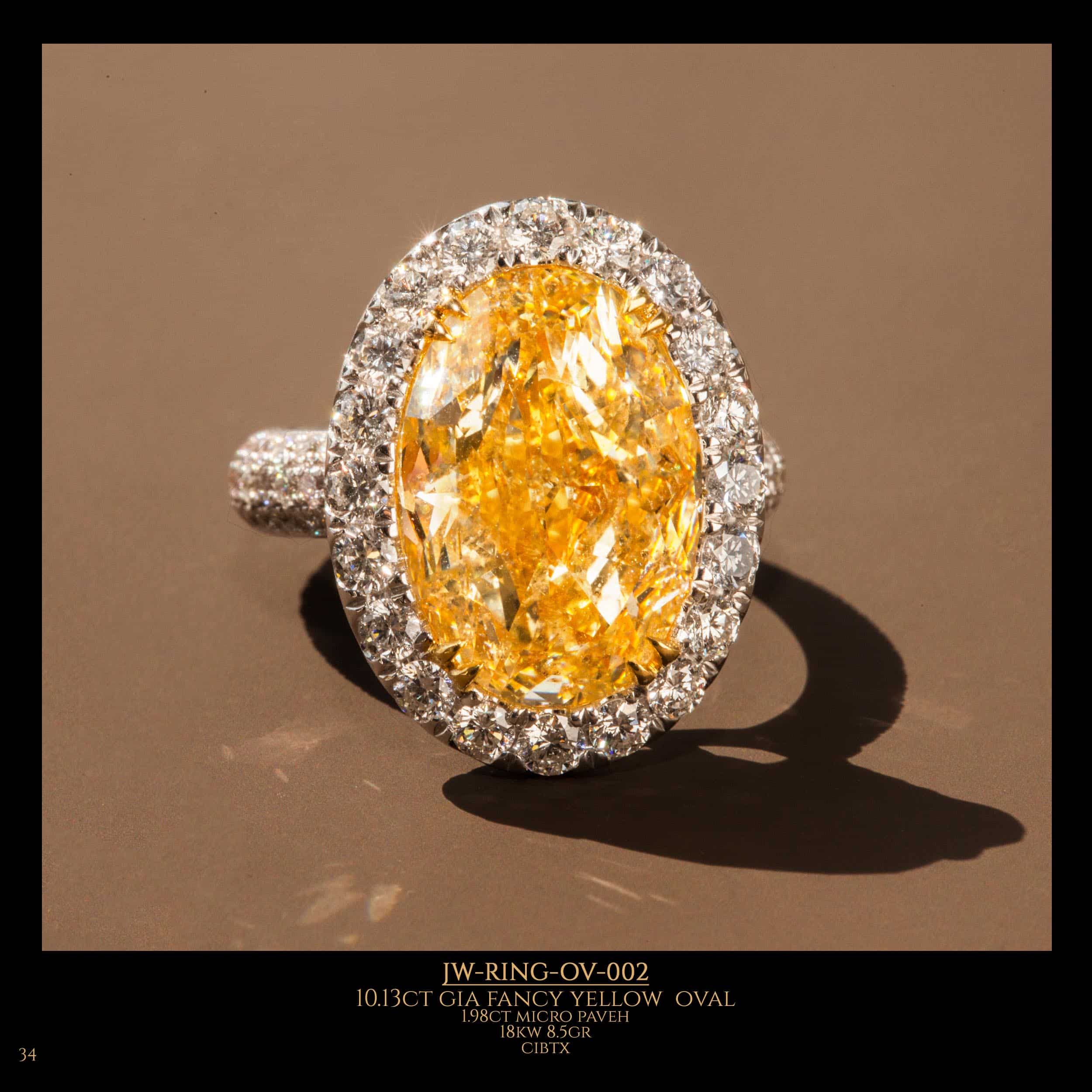 Oval shape diamond ring with fancy yellow oval diamond in the center