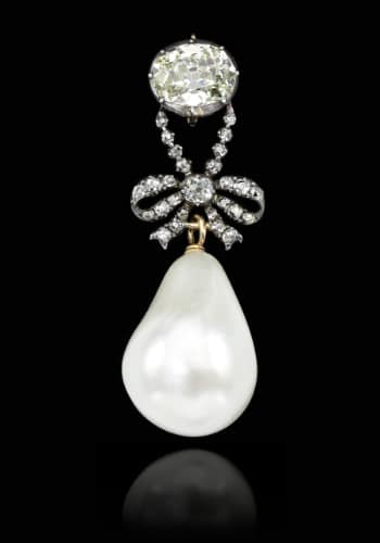 a diamond pendant necklace, featuring a large a natural pearl
