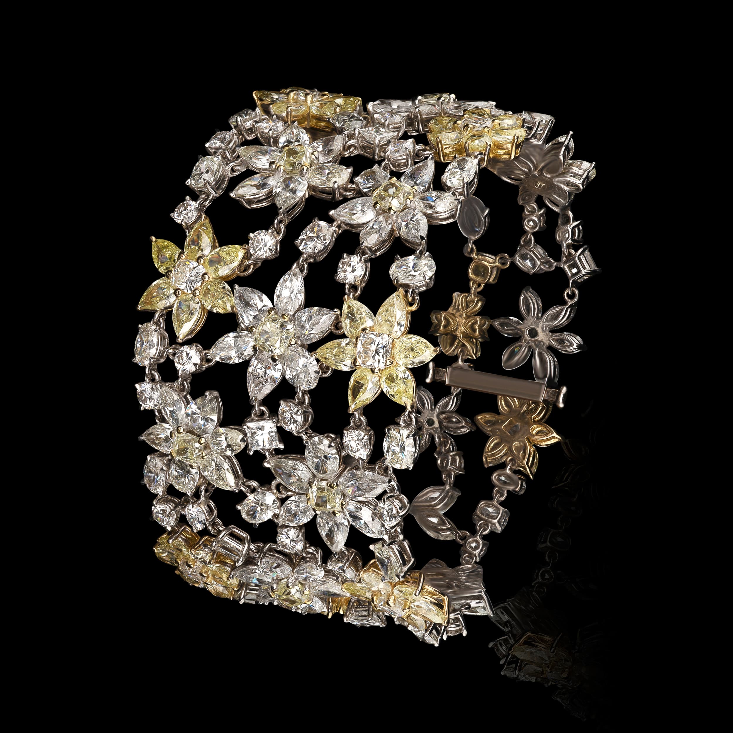 Closed diamond bracelet with flower shapes on black background