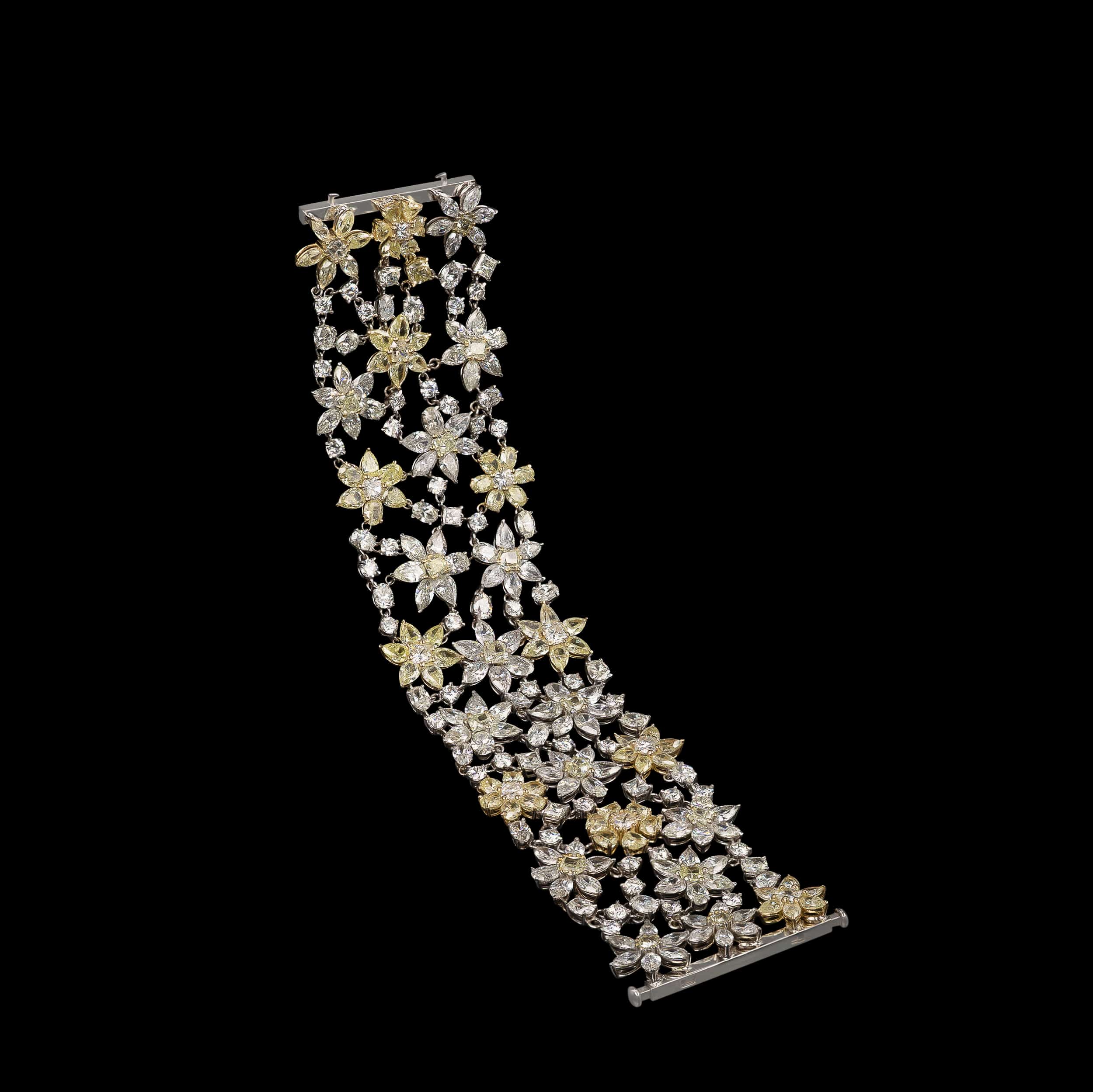 Open diamond bracelet with flower shapes on black background