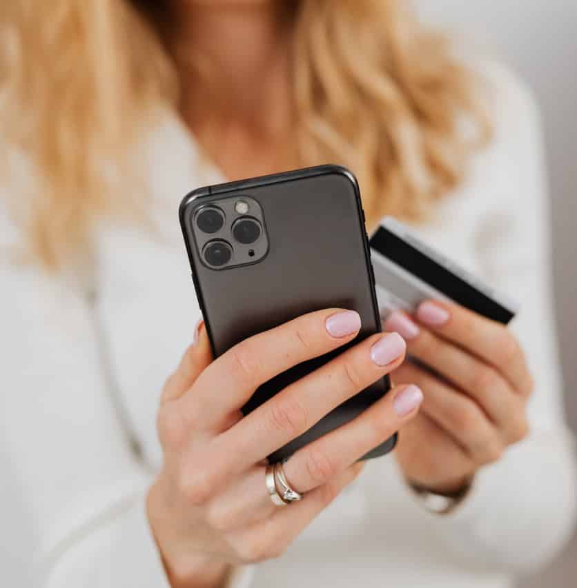 A woman makes an online purchase through the iPhone