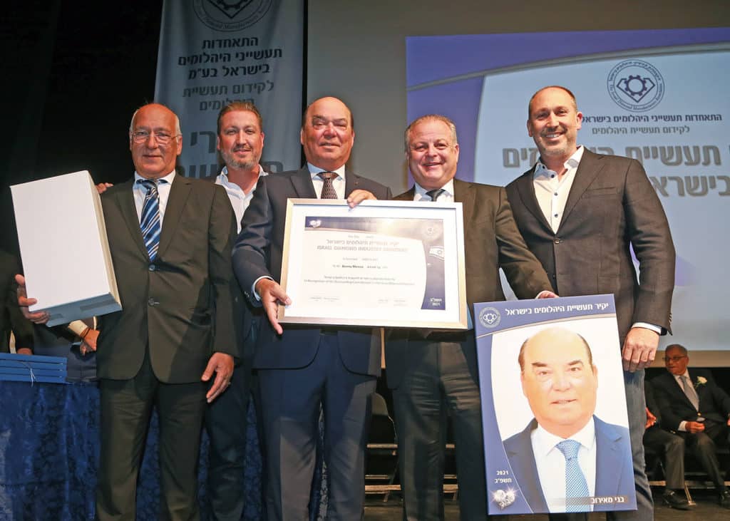 Benny Meirov (center) holding his 2021 Israel Diamond Industry Dignitary Award certificate, flanked (from left) by his brother and co-founder of MID House of Diamonds Yossi; his son Michael, MID’s CEO; Moti Ganz, President of the Israel Diamond Manufacturers Association; and his son Dotan, COO of MID