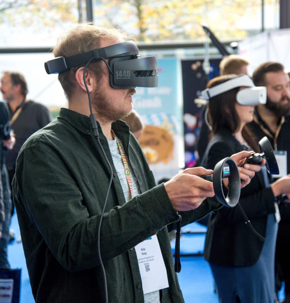 Immersed in the metaverse, using a virtual reality helmet and hand-held sensory devices.